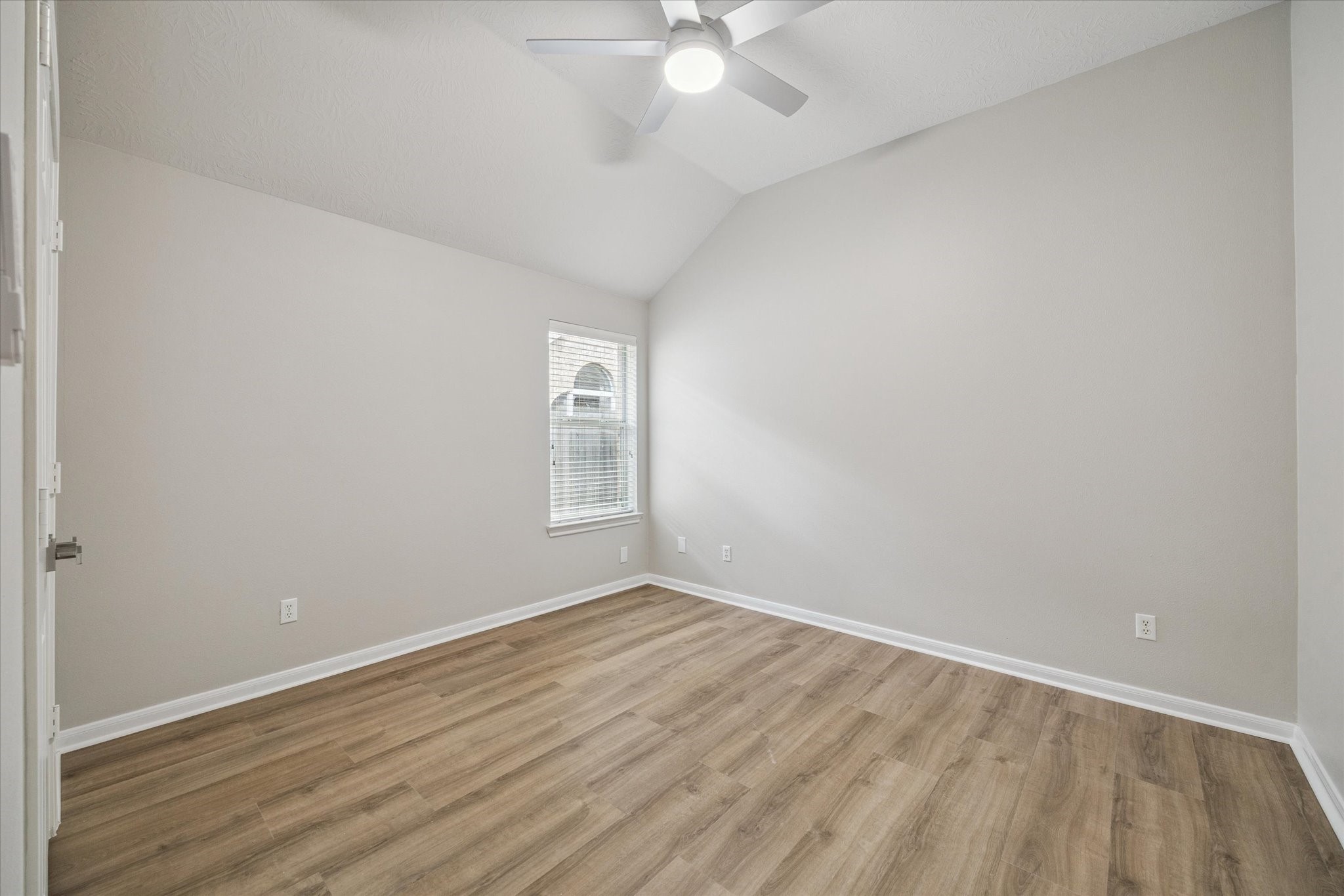 18747 Candle Park Drive Spring, TX 77388 - Photo 25 of 32 an empty room with wooden floor and windows