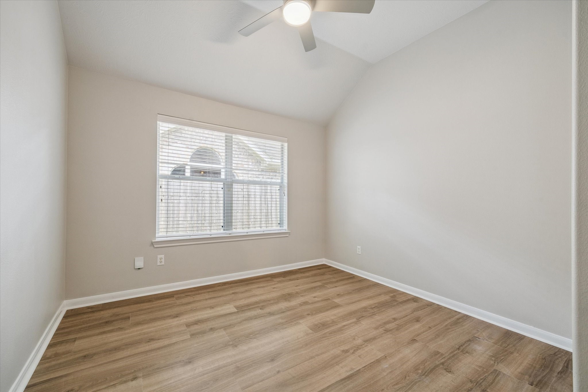 18747 Candle Park Drive Spring, TX 77388 - Photo 27 of 32 an empty room with wooden floor and windows