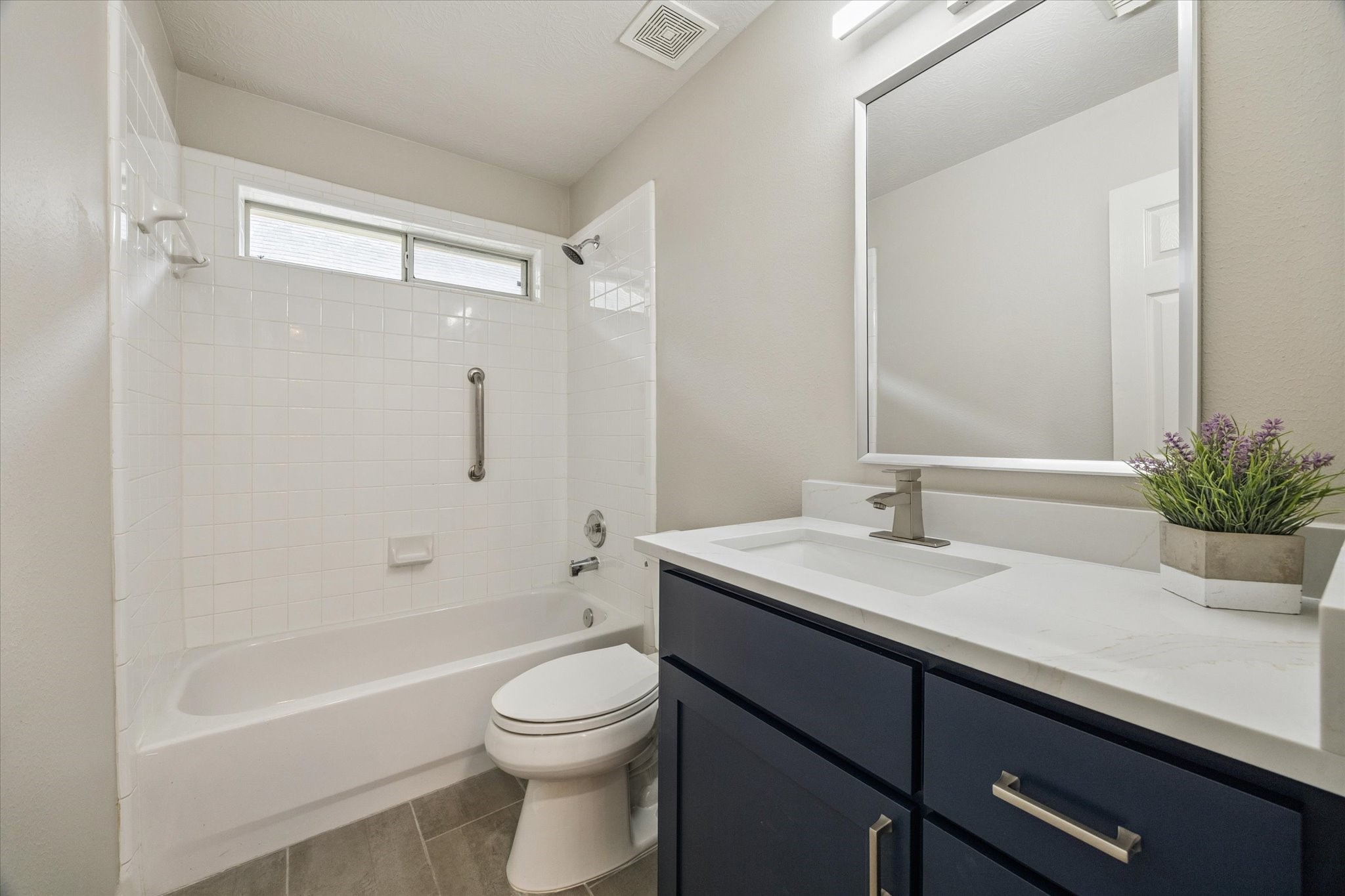 18747 Candle Park Drive Spring, TX 77388 - Photo 29 of 32 a bathroom with a granite countertop sink a toilet a mirror a bathtub and shower