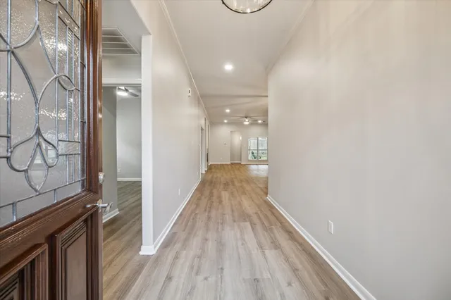 a view of hallway with wooden floor