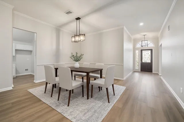 a view of a dining room with furniture and wooden floor