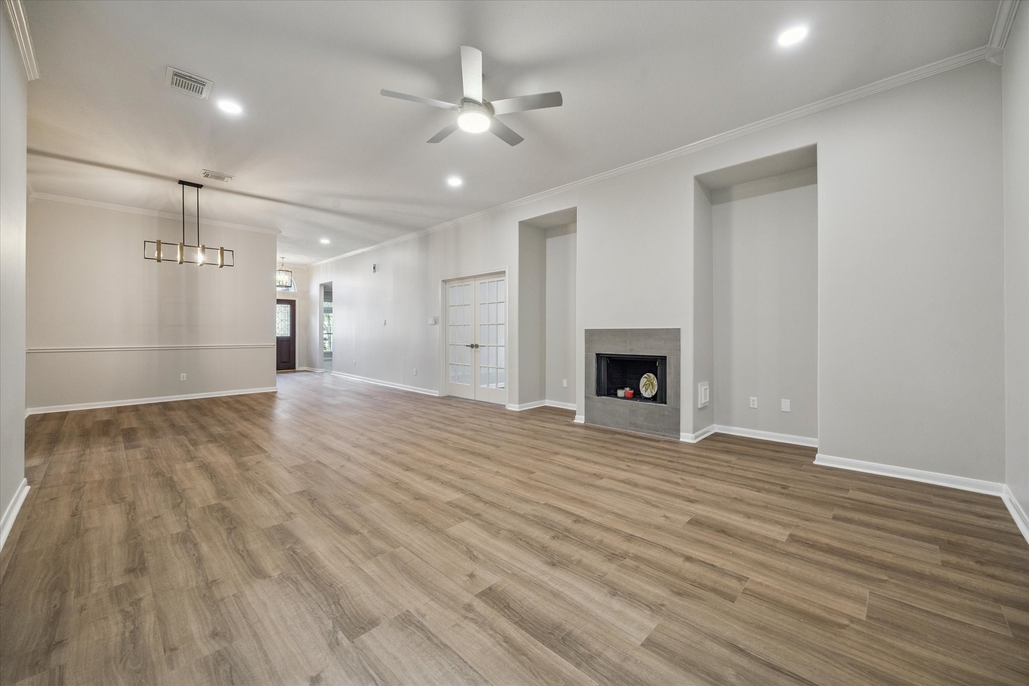18747 Candle Park Drive Spring, TX 77388 - Photo 7 of 32 a view of an empty room with wooden floor and a fireplace