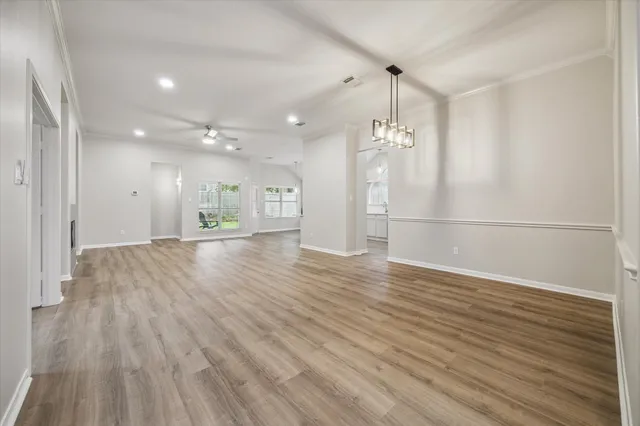a view of a room with wooden floor