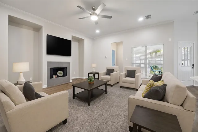 a living room with furniture a fireplace and a flat screen tv