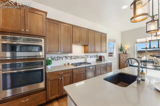 a kitchen with a stove a sink and a microwave