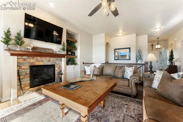a living room with furniture and a fireplace