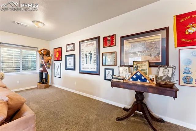 a view of a workspace with furniture and a window