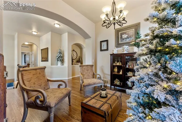 a living room with fireplace furniture and a chandelier