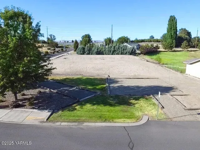 an aerial view of a house with a garden and trees