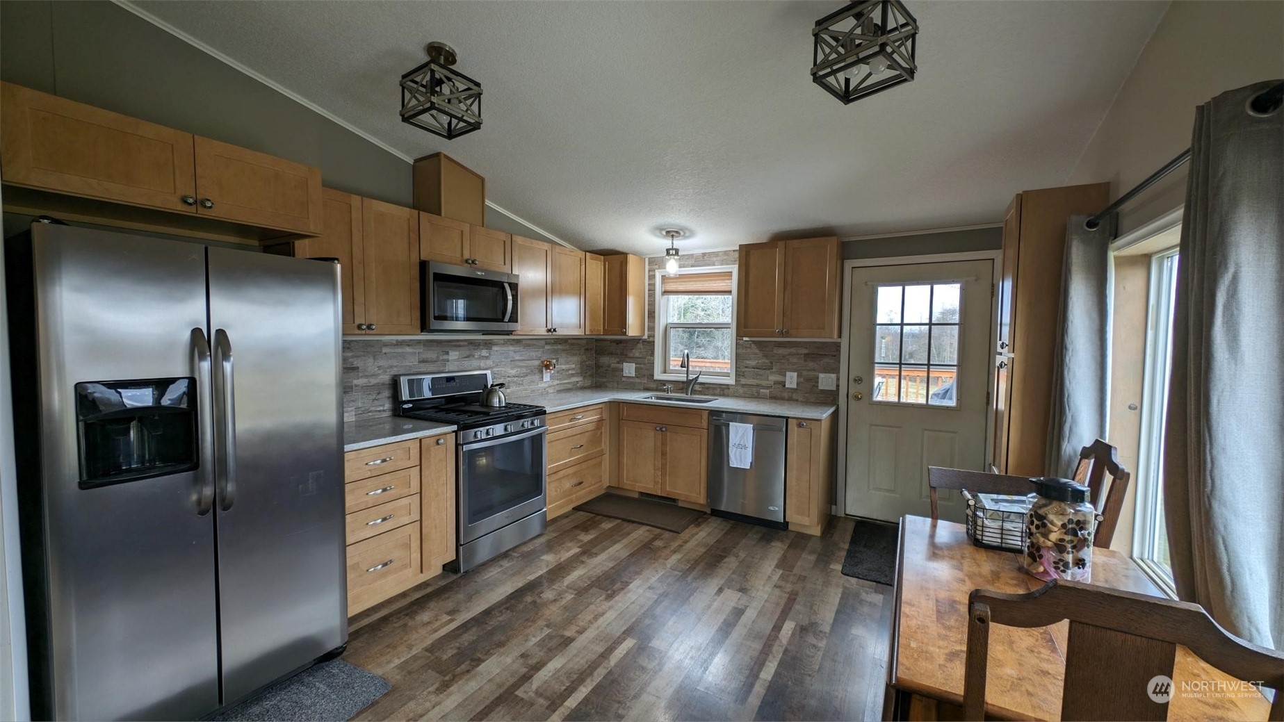 2790 Grandview Road Ferndale, WA 98248 - Photo 4 of 6 a kitchen with granite countertop a refrigerator a stove top oven a sink dishwasher and wooden cabinets