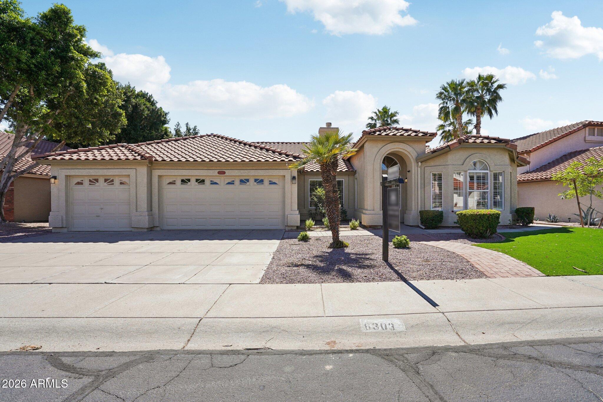 6303 West Melinda Lane Glendale, AZ 85308 - Photo 1 of 26 a front view of a house with garden