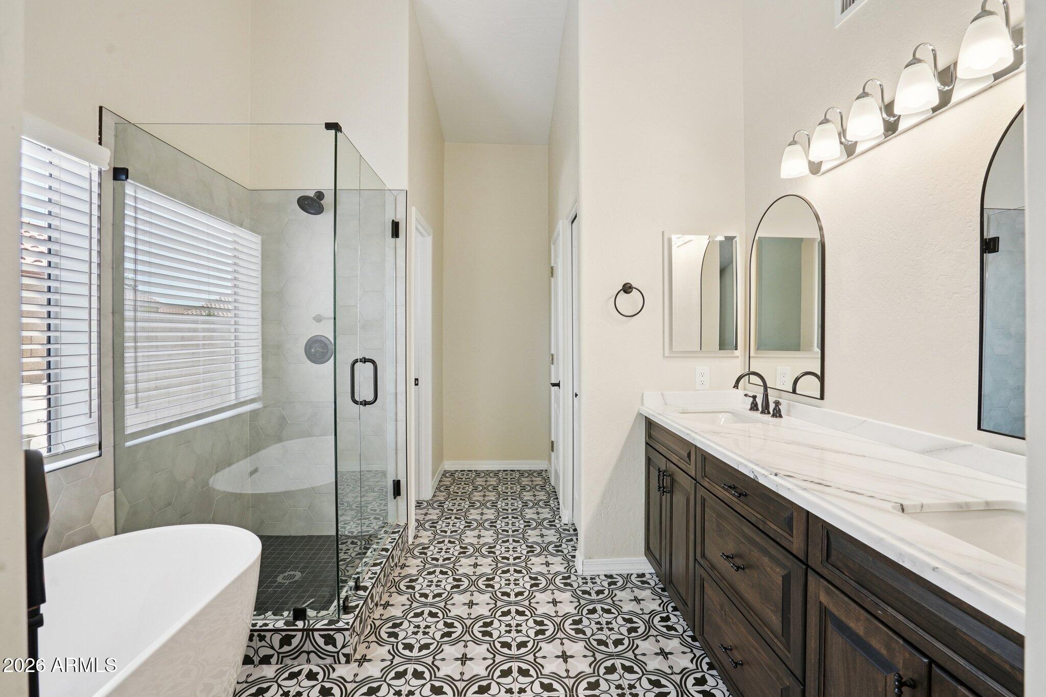 6303 West Melinda Lane Glendale, AZ 85308 - Photo 14 of 26 a spacious bathroom with a granite countertop sink mirror and a toilet