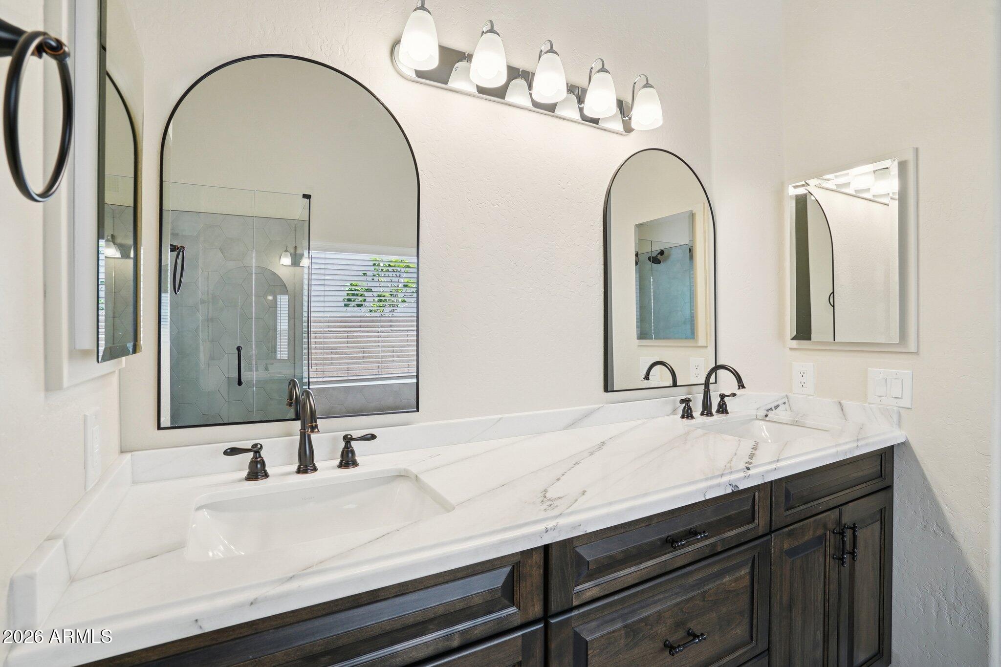 6303 West Melinda Lane Glendale, AZ 85308 - Photo 15 of 26 a bathroom with a double vanity sink and a mirror