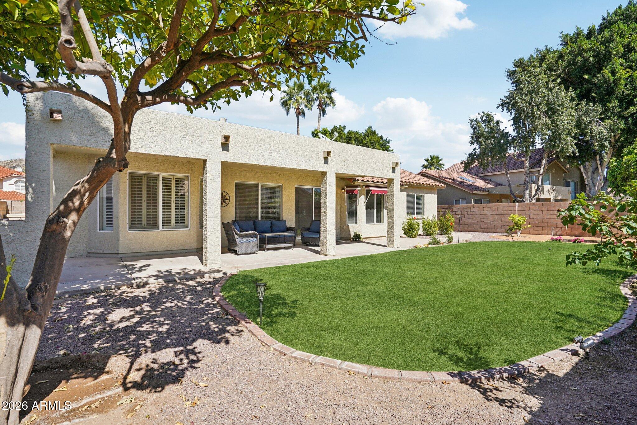 6303 West Melinda Lane Glendale, AZ 85308 - Photo 19 of 26 a front view of a house with a garden