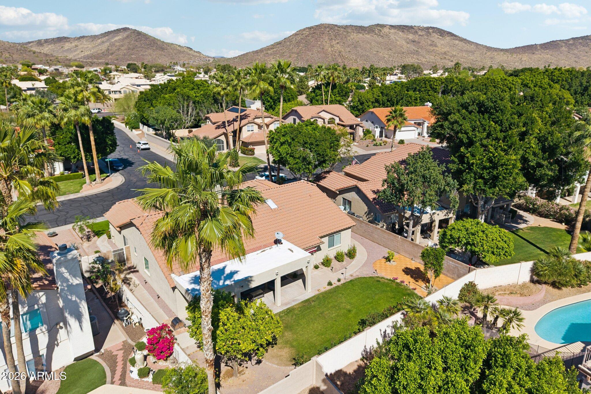 6303 West Melinda Lane Glendale, AZ 85308 - Photo 22 of 26 an aerial view of residential houses with outdoor space and trees