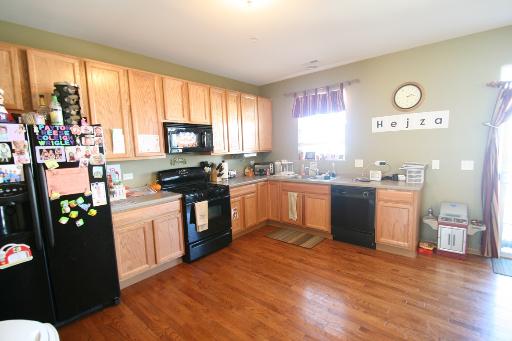 3843 Bailey Road Yorkville, IL 60560 - Photo 2 of 10 a kitchen with stainless steel appliances granite countertop a stove a sink and a microwave