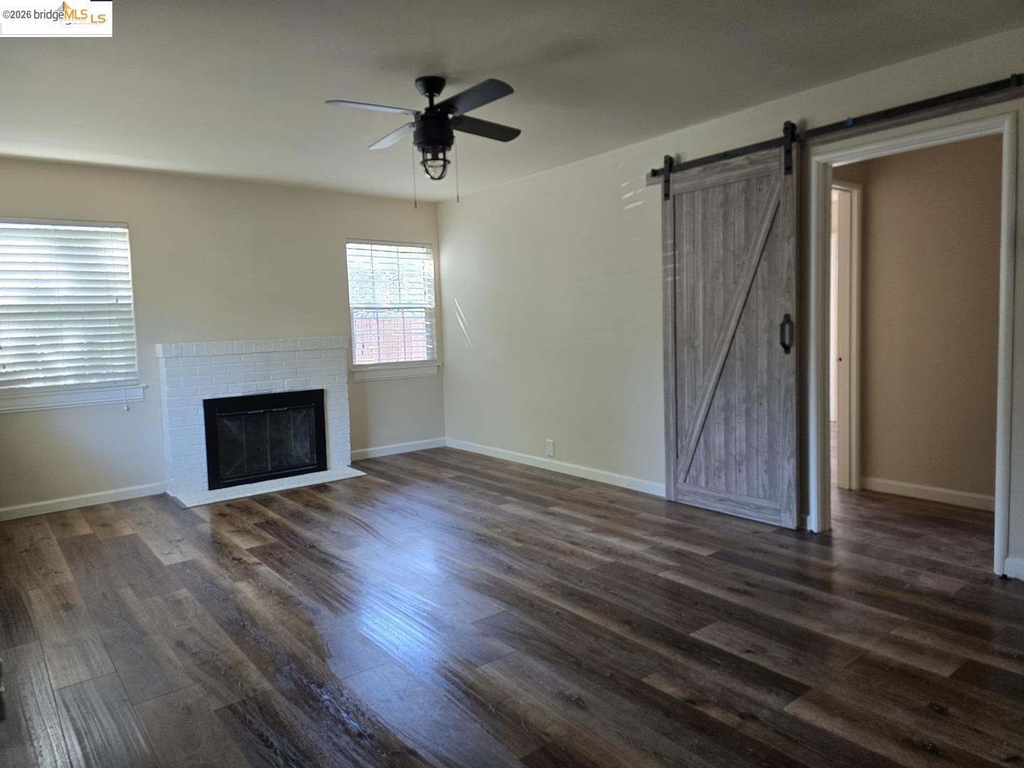 241 Humboldt Street San Rafael, CA 94901 - Photo 14 of 32 an empty room with wooden floor a ceiling fan and windows