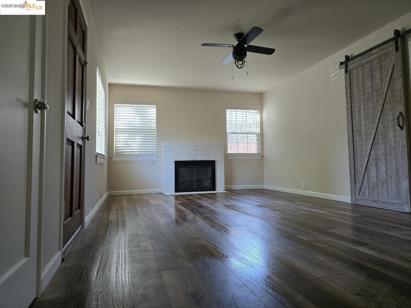 241 Humboldt Street San Rafael, CA 94901 - Photo 20 of 32 an empty room with wooden floor fan and windows