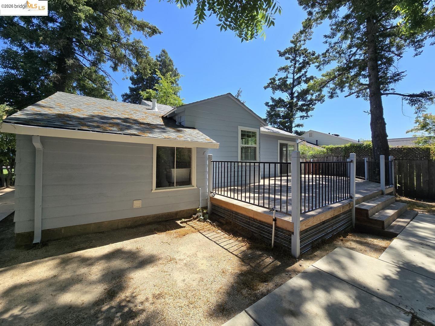 241 Humboldt Street San Rafael, CA 94901 - Photo 23 of 32 a view of a house with a wooden deck and a forest