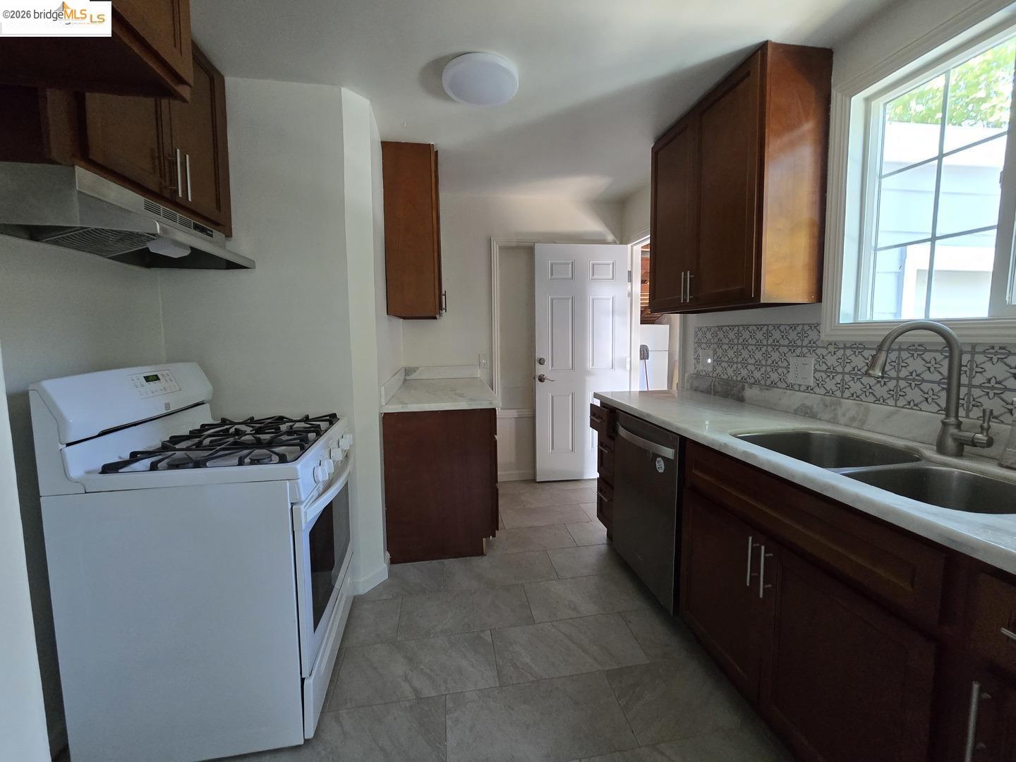 241 Humboldt Street San Rafael, CA 94901 - Photo 4 of 32 a kitchen with stainless steel appliances granite countertop a stove a sink dishwasher and a refrigerator