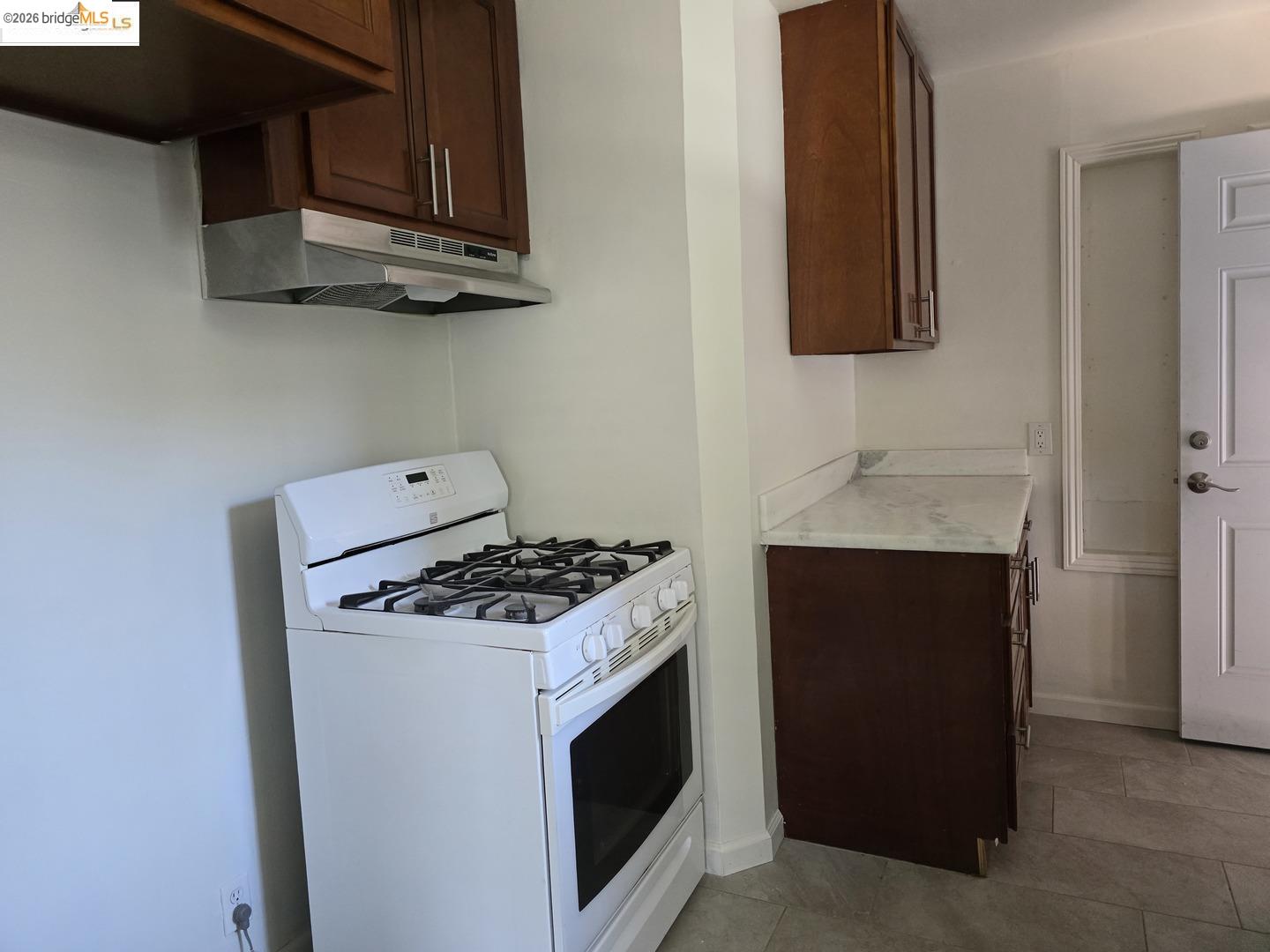 241 Humboldt Street San Rafael, CA 94901 - Photo 5 of 32 a kitchen with stainless steel appliances granite countertop a stove and a microwave