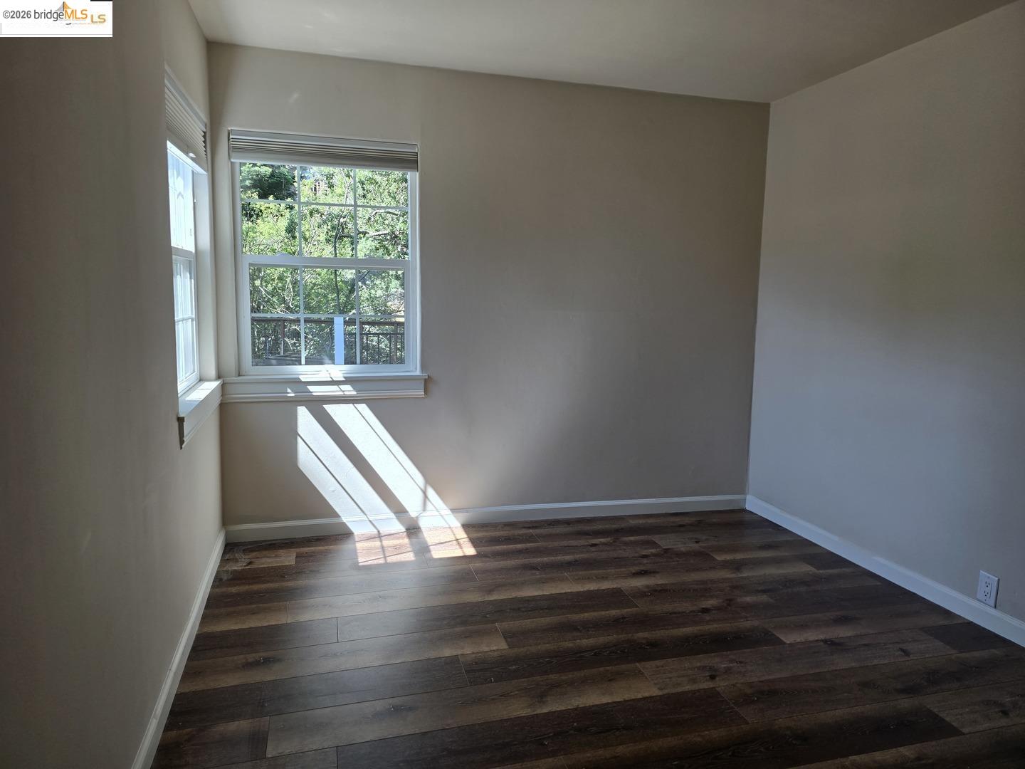 241 Humboldt Street San Rafael, CA 94901 - Photo 8 of 32 a view of an empty room with wooden floor and a window