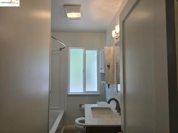 a bathroom with a sink a mirror and a window