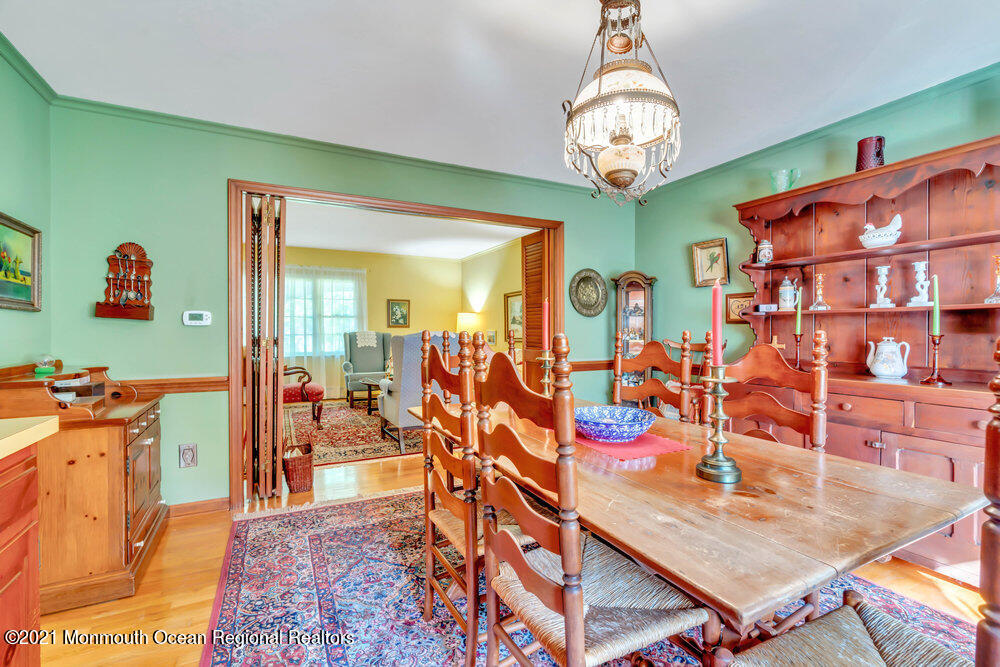 3234 Ridgewood Road Allenwood, NJ 08720 - Photo 16 of 49 a view of a dining room with furniture a chandelier and a rug