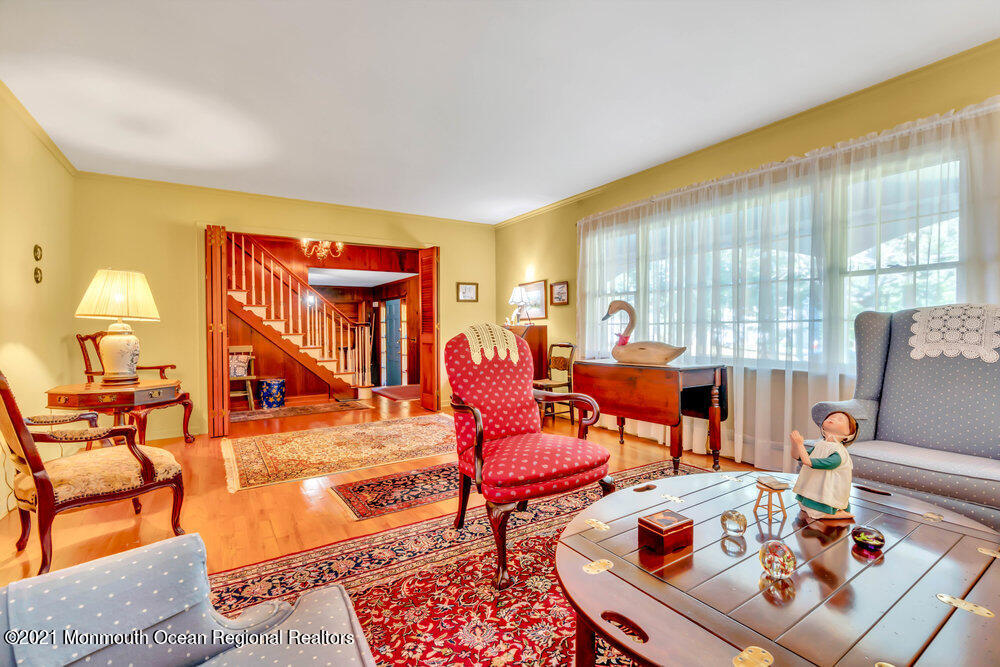 3234 Ridgewood Road Allenwood, NJ 08720 - Photo 17 of 49 a living room with furniture a fireplace and large windows