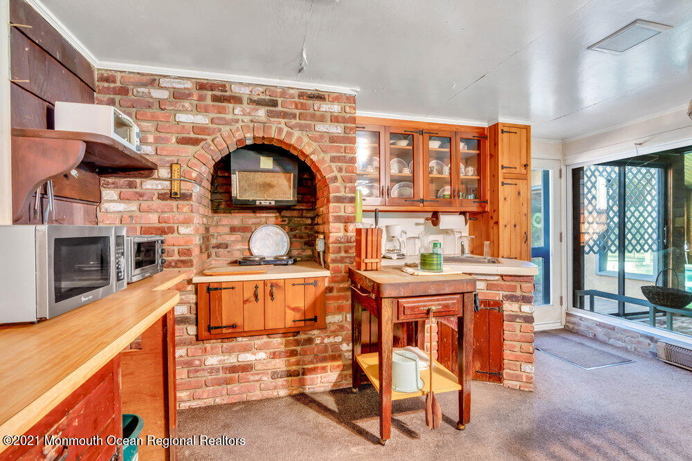 3234 Ridgewood Road Allenwood, NJ 08720 - Photo 22 of 49 a living room filled with furniture hardwood floor and a fireplace