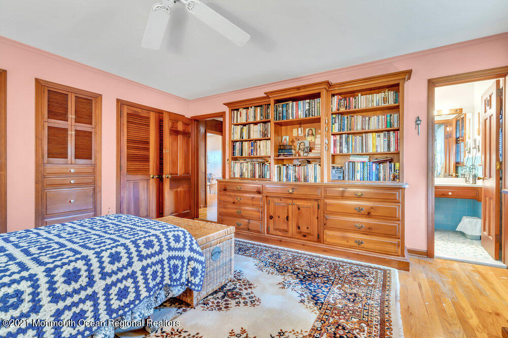 3234 Ridgewood Road Allenwood, NJ 08720 - Photo 33 of 49 a bedroom with a bed and wooden floor