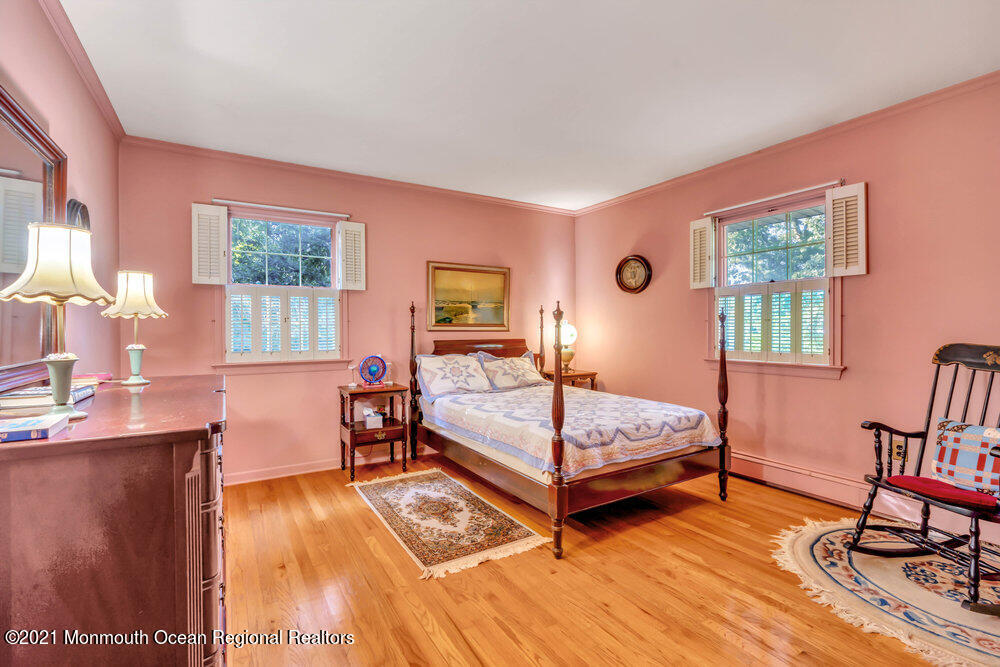 3234 Ridgewood Road Allenwood, NJ 08720 - Photo 39 of 49 a bedroom with a bed and wooden floor