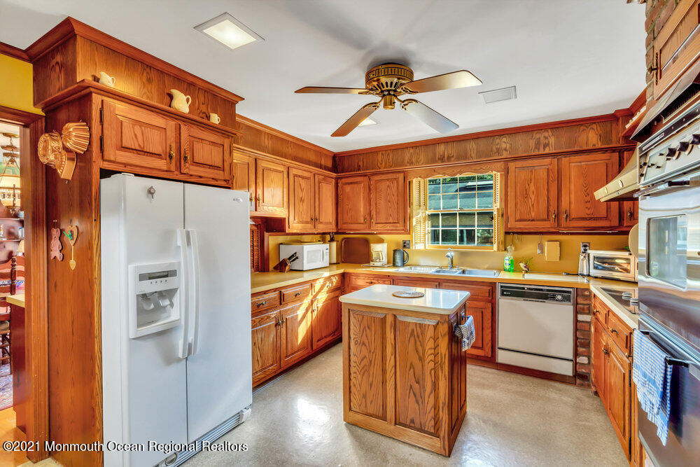 3234 Ridgewood Road Allenwood, NJ 08720 - Photo 6 of 49 a kitchen with stainless steel appliances a stove a refrigerator and cabinets