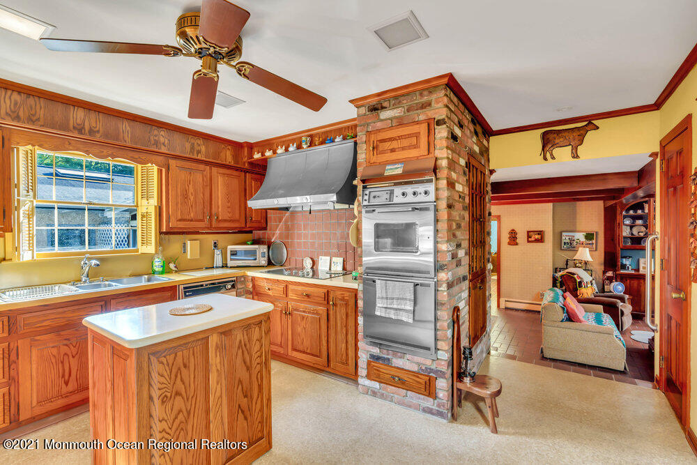 3234 Ridgewood Road Allenwood, NJ 08720 - Photo 8 of 49 a kitchen that has a lot of cabinets in it and wooden floors