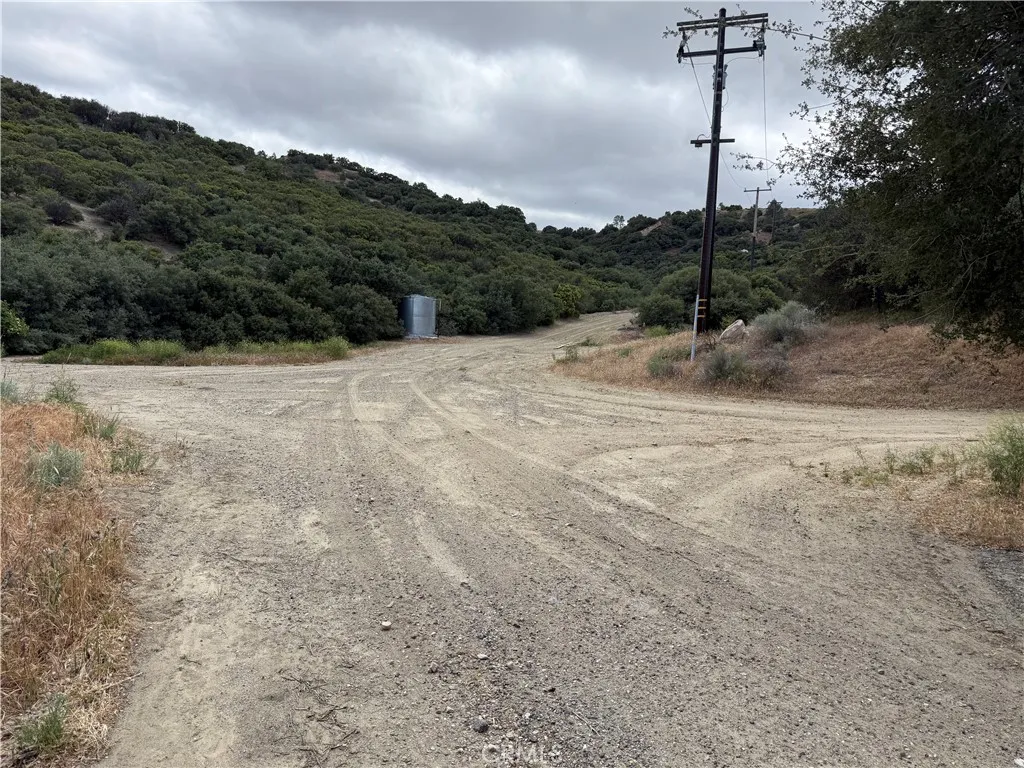 35442 Lancaster Road Lancaster, CA 93535 - Photo 4 of 26 a view of a dry yard with trees in the background