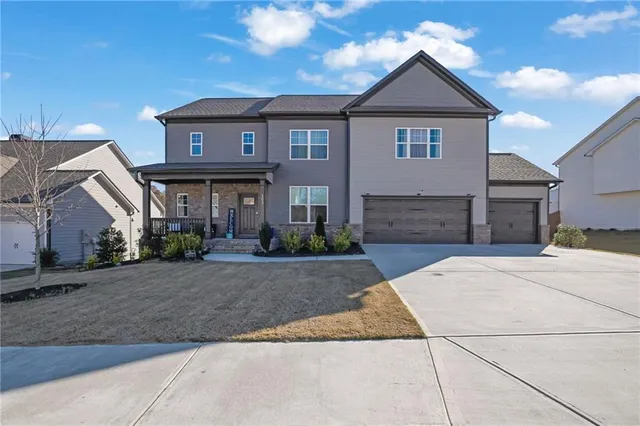 a front view of a house with a yard and garage