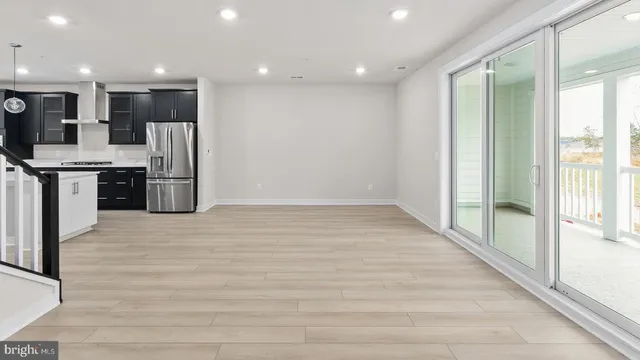 a large kitchen with stainless steel appliances granite countertop a refrigerator and a stove