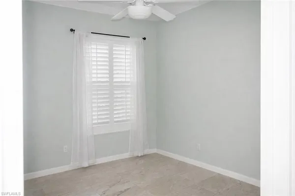 a bathroom with a granite countertop toilet and sink