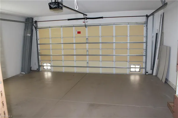 a view of a deck with a floor to ceiling window and potted plants