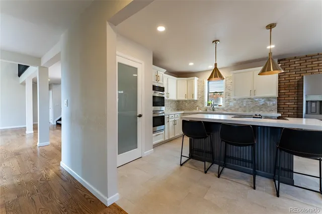 a large kitchen with a table and chairs