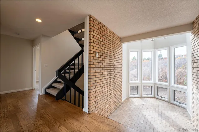 a view of entryway and hall with wooden floor