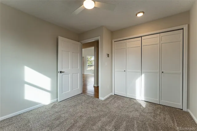 an empty room with windows and closet