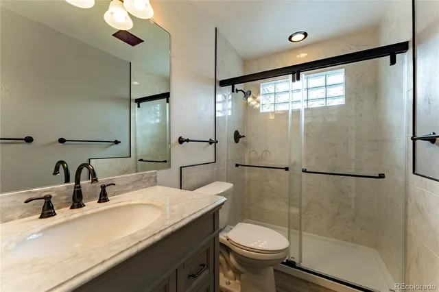 a bathroom with a sink toilet and shower