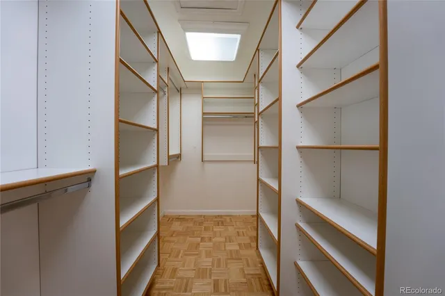 a view of walk in closet with empty racks