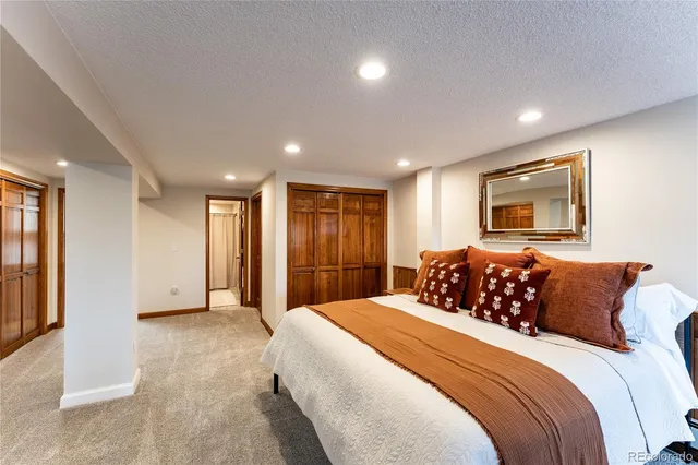 a bedroom with a large bed and a large mirror