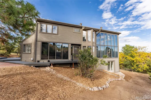 a view of a chair and table in the backyard