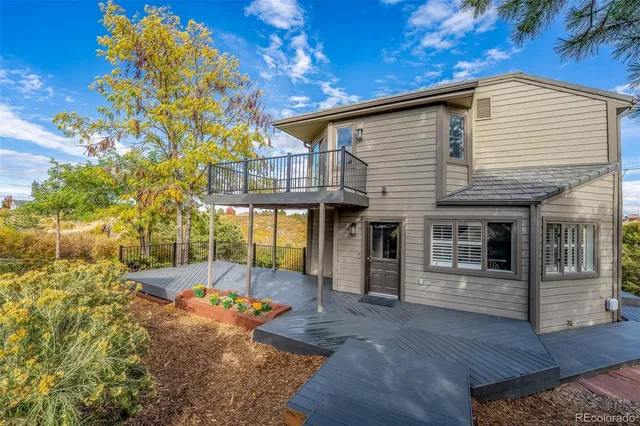 a backyard of a house with plants and trees