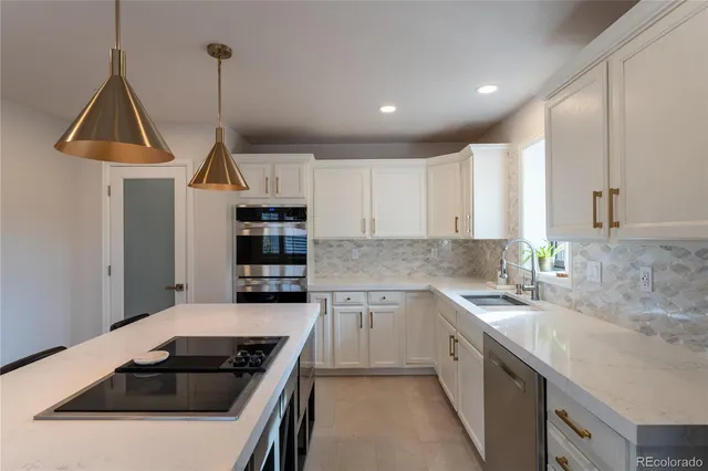 a kitchen with stainless steel appliances a sink stove and refrigerator
