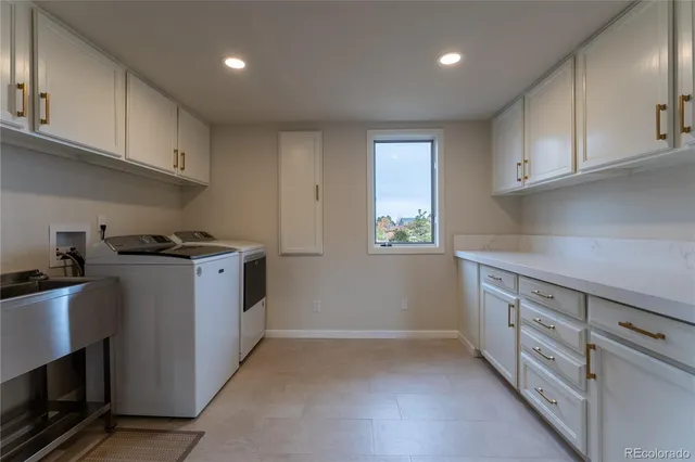 a kitchen with granite countertop white cabinets and stainless steel appliances