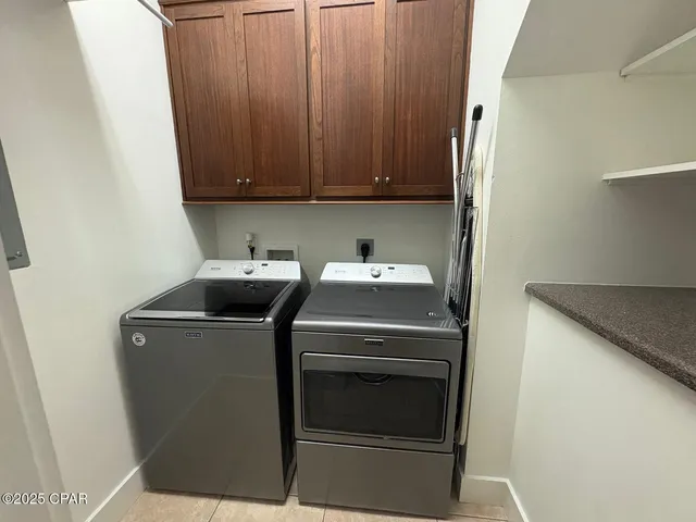 a view of a stone house with a yard and plants